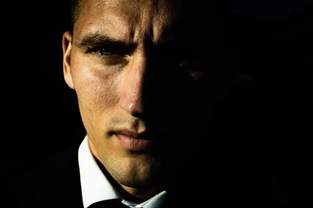 This image on the other hand is ultra sexy. The sharp hard shadow that cuts across the face tells a story. This is Wall Street guy unsure about his next move. | photo from unsplash